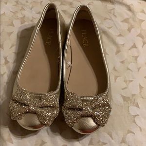 Children place little girl shoes